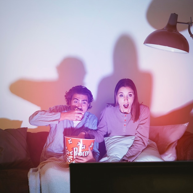 love,light,man,home,film,room,couple,tv,movie,lamp,watch,media,living room,popcorn,television,female,together,young,horror,entertainment
