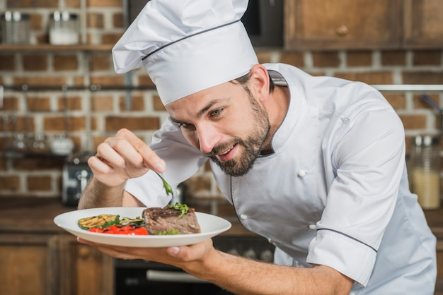 food,people,hand,restaurant,man,kitchen,table,chef,smile,happy,work,hotel,person,cook,decoration,job,meat,beard,healthy,plate