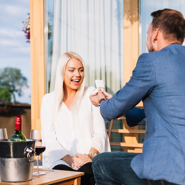 people,love,restaurant,man,box,table,wine,couple,person,bottle,ice,jewelry,ring,lady,suit,wooden,womens day,surprise,wood table,romantic