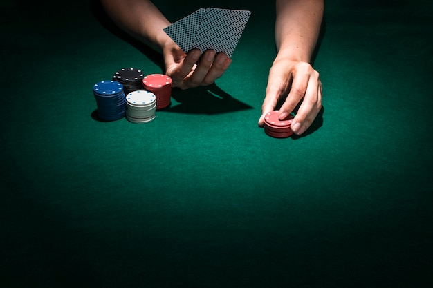 background,people,card,blue background,hand,green,blue,table,red,black background,black,colorful,human,game,board,person,backdrop,white,success,casino
