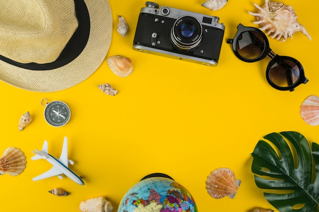 background,leaf,map,camera,table,earth,airplane,yellow,yellow background,hat,compass,studio,stand,shell,direction,bright,traveler,object,explore,sunglass