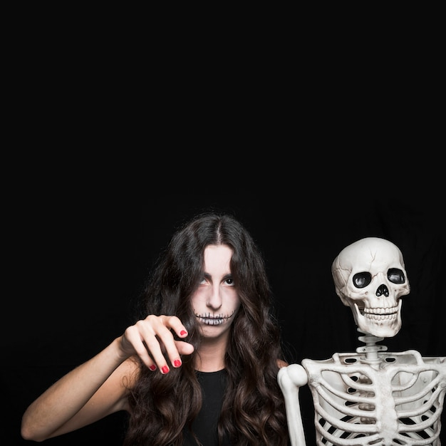 background,hand,halloween,woman,camera,black background,space,celebration,black,white background,holiday,square,carnival,makeup,white,decoration,magic,lady,studio,halloween background,background black,zombie,bone,female,young,witch,skeleton,horror,celebration background,background white,beautiful,square background,beauty woman,season,crazy,dead,wizard,copy,looking,spooky,rising,format,trick,horrible,mystical,gloomy,charming,pale,near,sorceress,at,copy space,bleak,looking at camera,ashy,enchantress,murk,square format