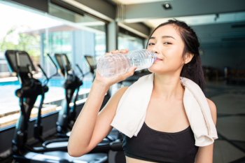 women with bottles of water in gym, Stock image