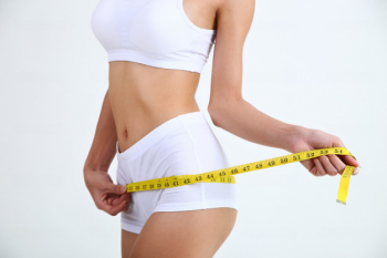 Young woman measuring waist with a tape stock photo (182967) -  YouWorkForThem