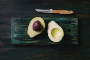 Halves of fresh avocado on a cutting board. 31996423 Stock Photo at Vecteezy