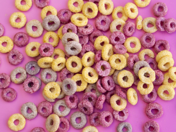 Free Photo  Coloured fruity loops and milk on pink background