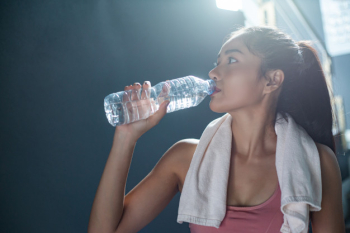 women with bottles of water in gym, Stock image