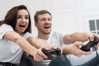 Cheerful boyfriend and girlfriend playing video games to win. Happy couple  using controller to play online game and winning gameplay on console.  People holding joystick to have fun Stock Photo - Alamy