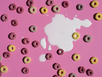 Free Photo  Coloured fruity loops and milk on pink background
