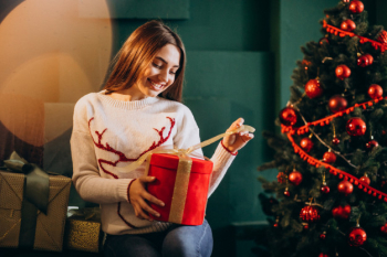 Premium Photo  Young mom with kids holding christmas presents