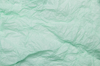 Crumpled mint green paper textured background