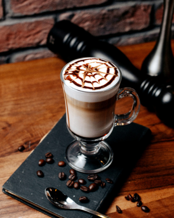 latte macchiato, pouring espresso in glass, pitcher with coffee, milk foam,  energy and caffeine Stock Photo by LightFieldStudios