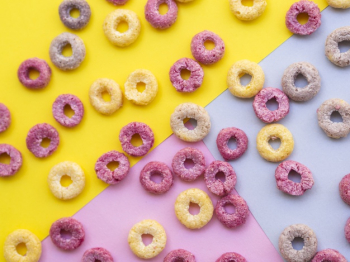 Free Photo  Coloured fruity loops and milk on pink background