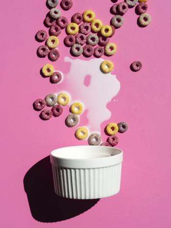 Free Photo  Coloured fruity loops and milk on pink background