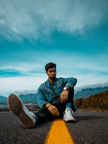 A man sitting on the side of a road photo – Cool guy Image on Unsplash