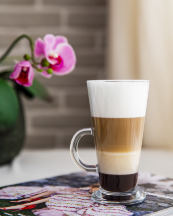 Glass with latte macchiato on white background Stock Photo