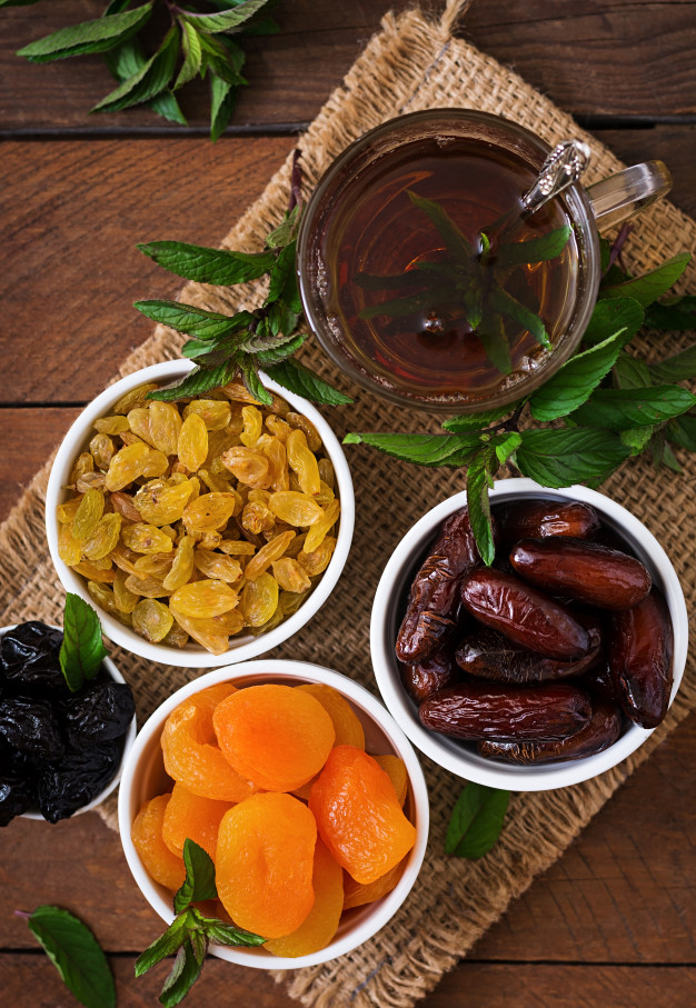 Dried figs, dried apricots and prunes in a mix with almonds in a