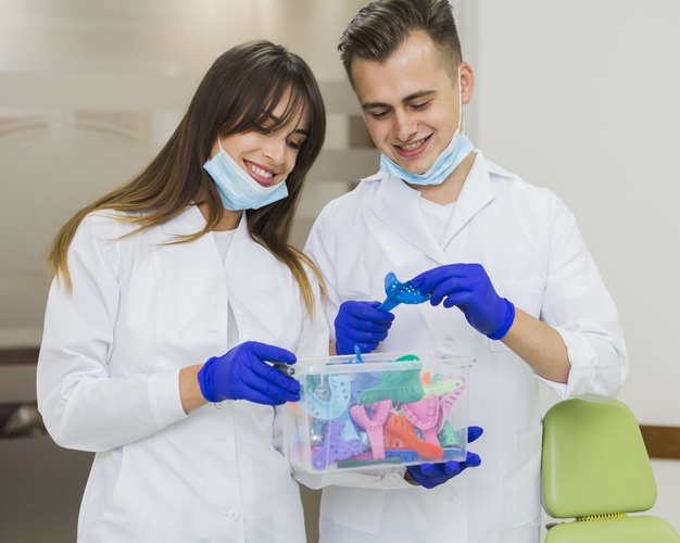 practitioner,retainers,orthodontist,surgical gloves,front view,oral hygiene,medics,dentists,stomatology,surgical,oral,front,smiling,technician,horizontal,dentistry,hygiene,holding,male,gloves,view,female,dental,medicine,health,box,man,woman