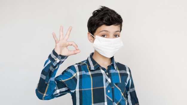 quarantine,coronavirus,covid19,pandemic,high angle,medical mask,ok sign,illness,prevention,fever,high,cough,indoor,dangerous,angle,horizontal,protection,young,ok,mask,boy,sign,child,kid,medical