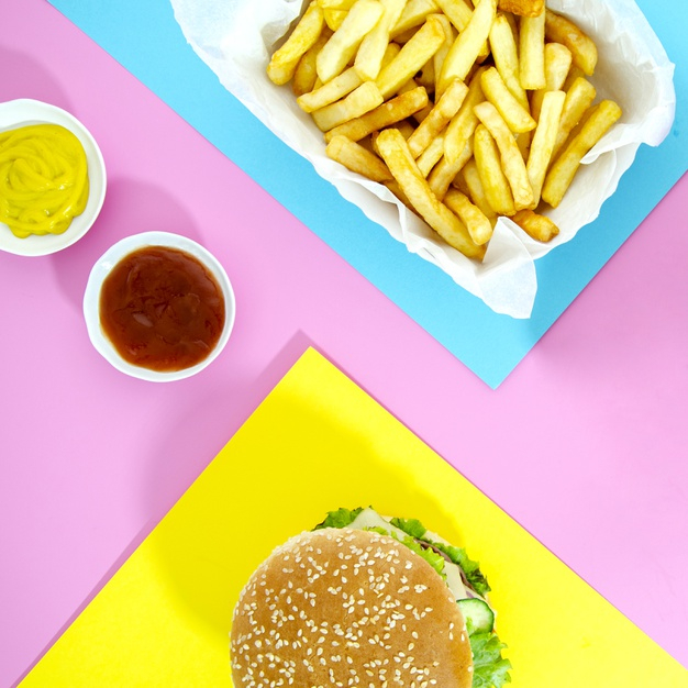sesame seeds,lay,squared,patty,mustard,calories,sesame,tasty,potatoes,tomatoes,ketchup,seeds,lettuce,flat lay,fries,french,french fries,fast,cheese,meat,energy,flat,burger,yellow,pink,blue,restaurant,food,background