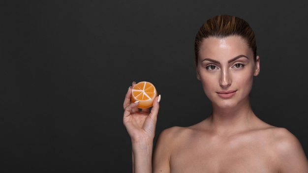 slice,confident,treatment,horizontal,adult,holding,therapy,skincare,portrait,beautiful,wellness,skin care,young,female,healthcare,care,skin,clean,healthy,product,cosmetic,body,orange,face,cute,health,beauty,girl,woman
