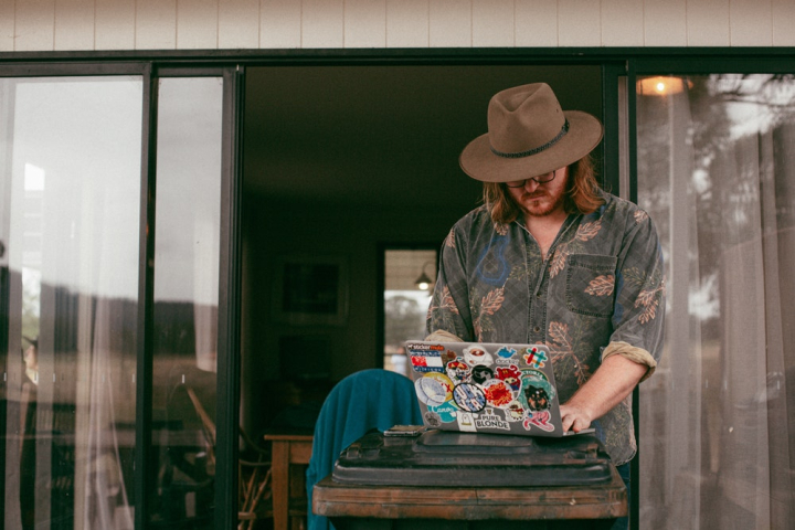 dj,hat,laptop,man,man using laptop