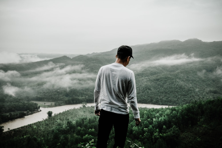 Free: Photo of Man Standing at the Edge of a Cliff 