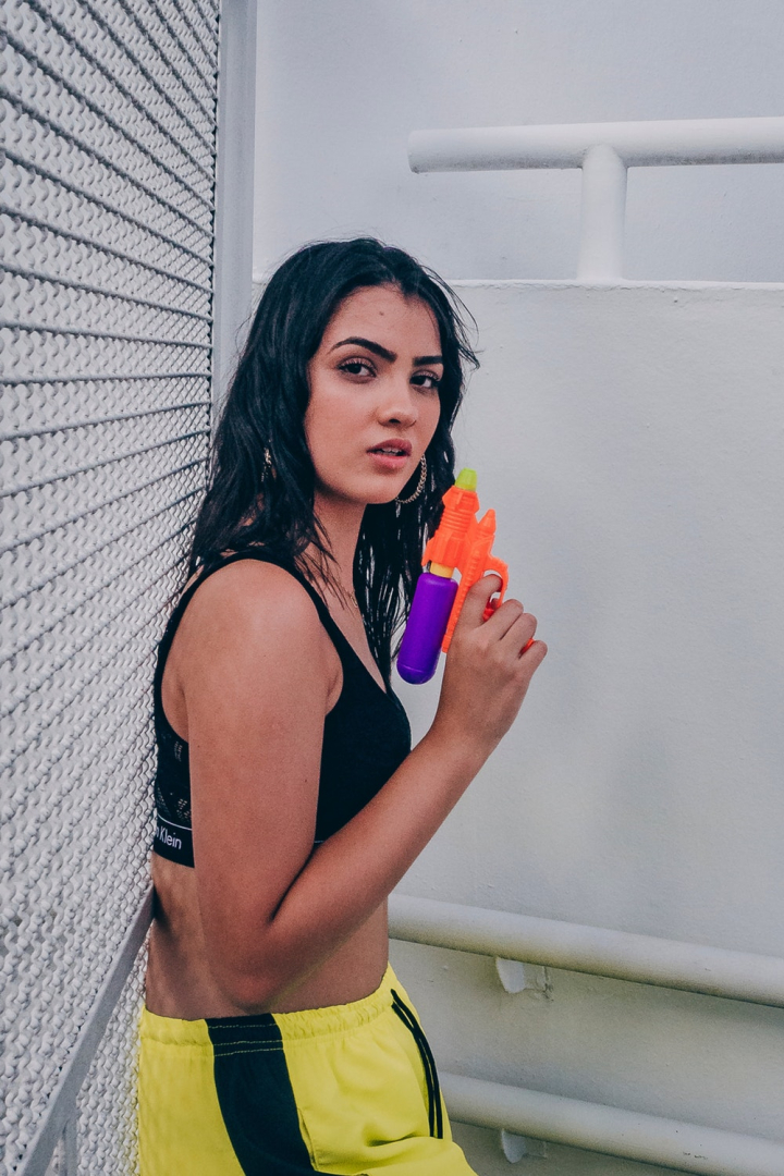 adult,attractive,beautiful,beauty,cute,face,facial expression,fashion,female,glamour,leaning,looking,model,person,photoshoot,pose,posing,posture,pretty,sexy,sports bra,toy gun,water gun,wear,woman