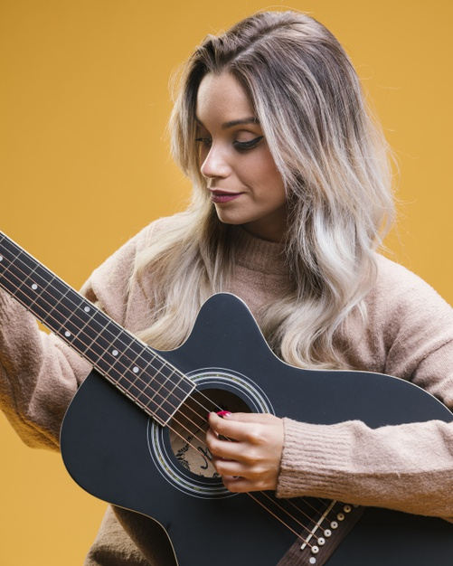 Free: Pretty woman playing guitar against yellow background Free Photo -  nohat.cc