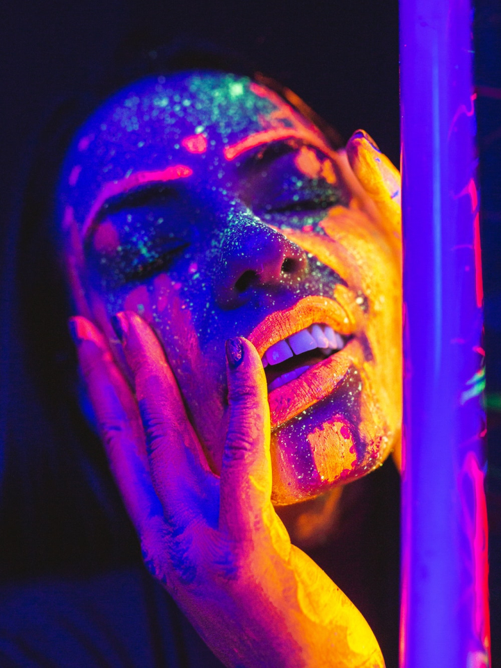 art,artistic,blacklight reactive,close-up,closed eyes,colorful,colors,conceptual,concert,face,face paint,female,festival,fluorescent paint,glow,glow in the dark,glowing,hands,light,lips,luminous,model,mouth,neon,neon glow,painting,party,person,portrait,pose,style,teeth,ultraviolet,woman