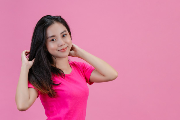 Woman with curly afro hair with sunglasses model poses on a pink background  in a pink T-shirt, free Stock Photo by shotprime