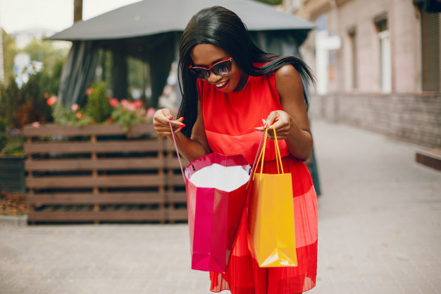 Fashion black woman with shopping bags in city or happy with sale, discount  or luxury retail