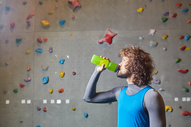 activewear,pursuit,refreshment,alpinism,sportsman,courage,sporty,recreation,climber,leisure,extreme,active,adult,curly,hobby,vest,guy,drinking,athlete,activity,plastic,climbing,young,training,drink,bottle,person,sport,man,water