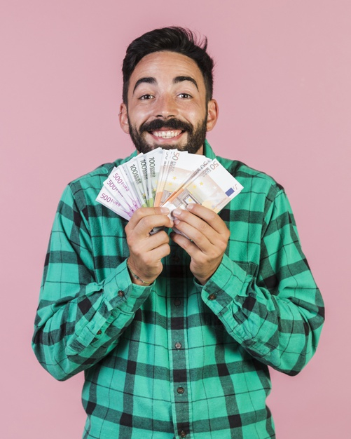 medium shot,looking at camera,front view,indoors,medium,bearded,banknotes,posing,joyful,brunette,euros,facial expression,casual,feature,handsome,front,looking,shot,holding,guy,facial,gesture,joy,male,euro,portrait,expression,happiness,view,emotion,young,youth,studio,fun,smiley,pink background,happy,smile,cute,pink,man,camera,green,money,background