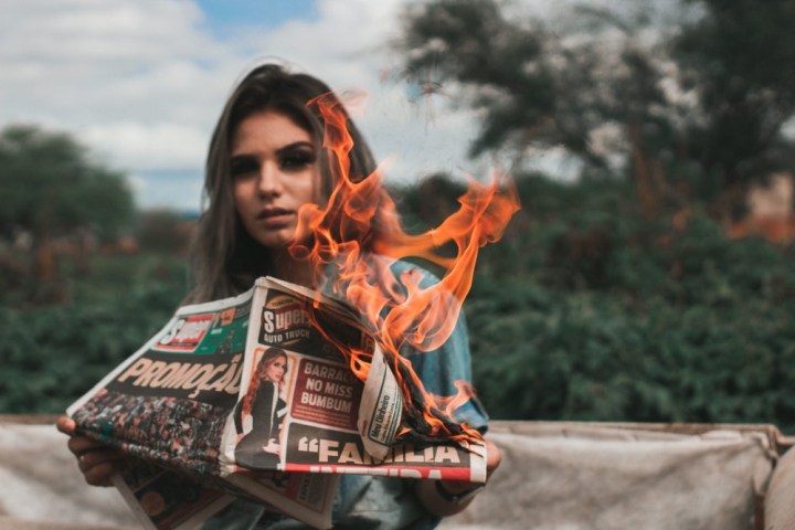 burning,flame,newspaper,person,woman
