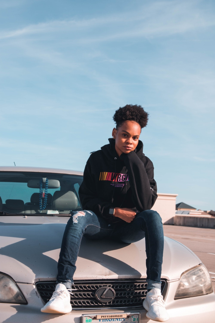 Free Person Wearing Black Hoodie and Blue Denim Jeans Sitting on