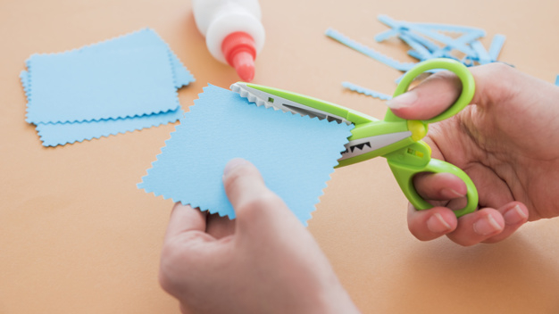 Colorful Scissor That Cut A Zigzag Pattern Stock Photo - Download