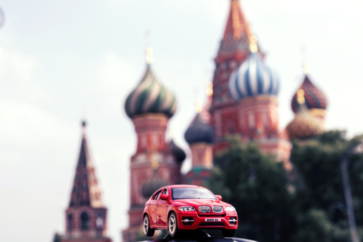 architecture,bmw,car,close-up,daylight,front,metal,model car,modern,outdoors,red,sightseeing,toy,toy car