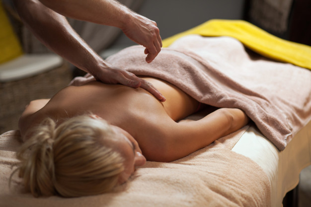 Body care. Woman enjoying relaxing back massage Stock Photo by