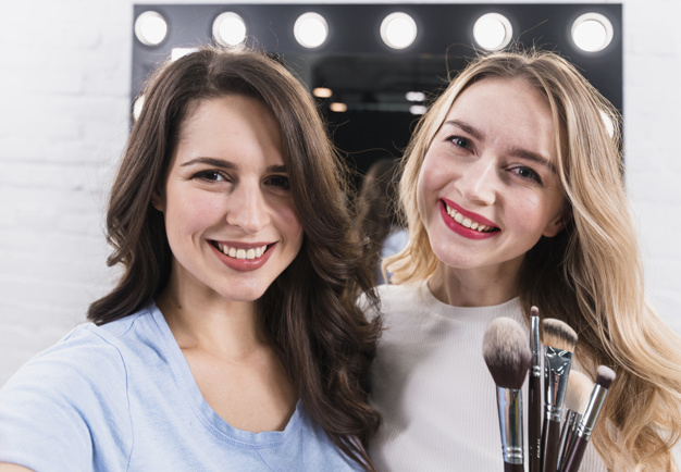 looking at camera,toothy,indoors,taking,glad,posing,brunette,long,visage,cheerful,stylist,blonde,two,long hair,looking,smiling,pretty,horizontal,master,joy,lifestyle,portrait,client,artist,hairstyle,brushes,professional,young,female,picture,care,selfie,studio,customer,lady,mirror,fun,cosmetic,modern,lamp,makeup,women,work,happy,face,cute,brush,beauty,hair,fashion,camera,woman