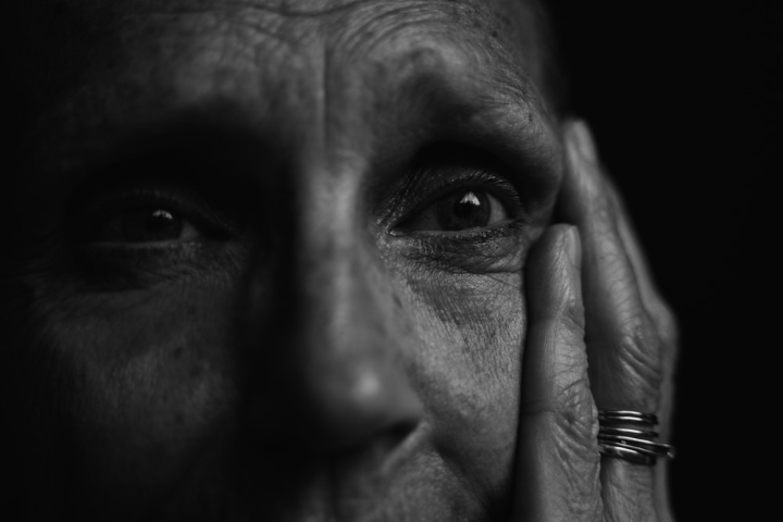 black-and-white,blur,close-up,dark,elder,elderly,eyes,face,facial expression,fingers,focus,model,monochrome,old,old age,old person,pensive,person,photoshoot,ring,senior,serious,wrinkles