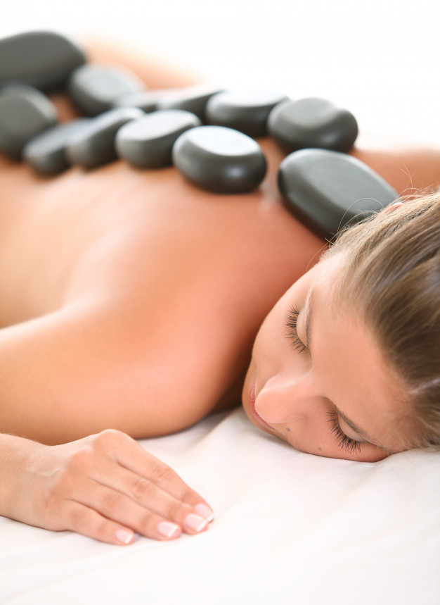 Body care. Relaxed woman enjoying back massage Stock Photo by