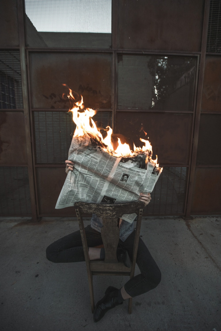 burning,fire,flame,newspaper,person