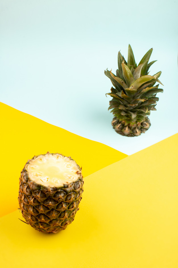 Blue Pineapple On Yellow Background Stock Photo - Download Image
