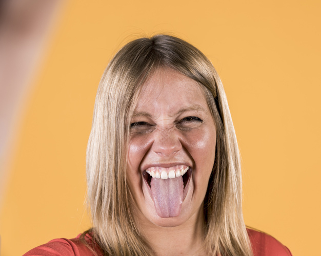 impairment,sticking,expressive,closeup,against,vibrant,cheerful,blonde,disable,deaf,front,surface,smiling,pretty,plain,one,adult,tongue,cheer,facial,bright,disability,expression,beautiful,happiness,young,female,studio,lady,funny,person,backdrop,yellow,human,happy,smile,beauty,hair,woman,people,background