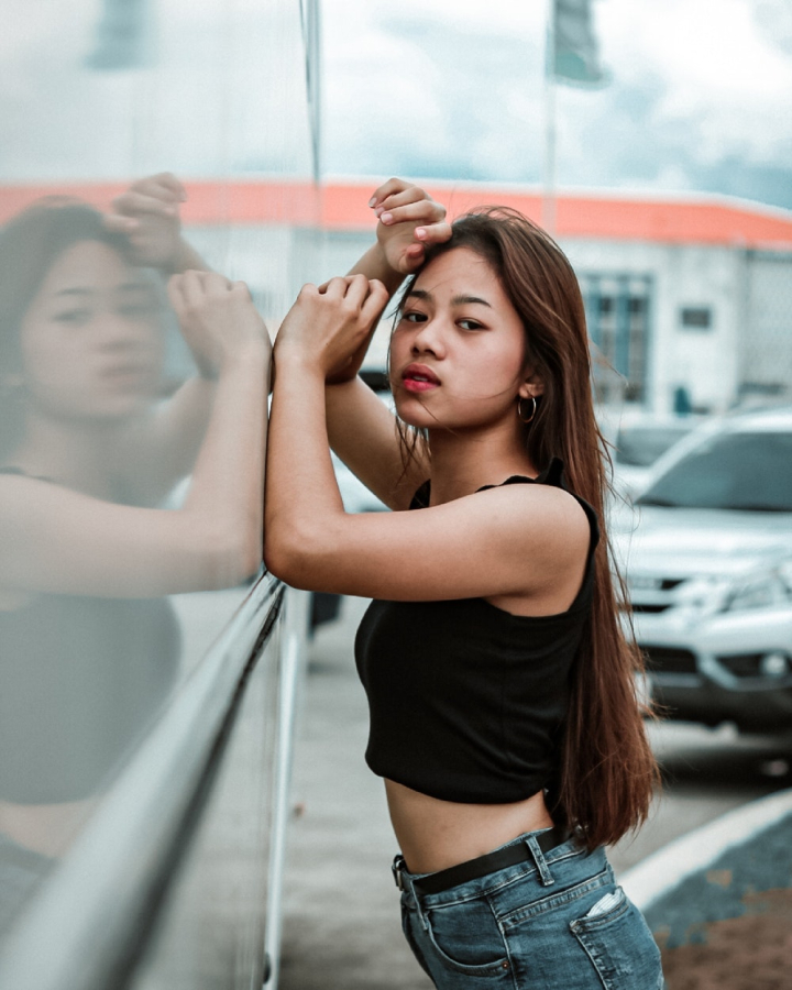 Beautiful Woman in a Black Crop Top and Denim Jeans Posing · Free