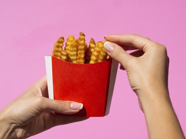 grabbing,calories,ingredient,tasty,horizontal,delicious,fries,french,american,french fries,meal,snack,fast,lunch,eat,fast food,energy,pink background,pink,restaurant,hand,food,background