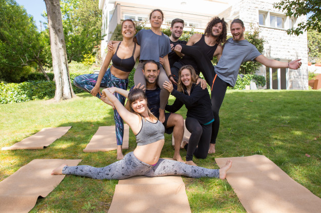 Free: Cheerful people from yoga team posing outdoors Free Photo