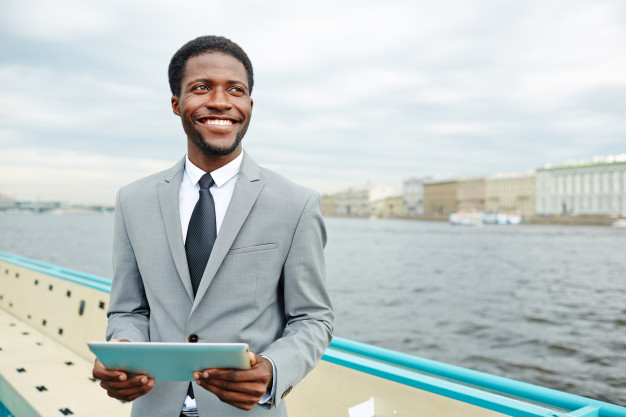 picturesque,businessperson,using,enjoying,upper,browsing,confident,african american,vessel,deck,looking,smiling,american,surfing,portrait,view,manager,fresh,entrepreneur,air,young,african,suit,motor,tablet,email,ship,businessman,internet,happy,man,business