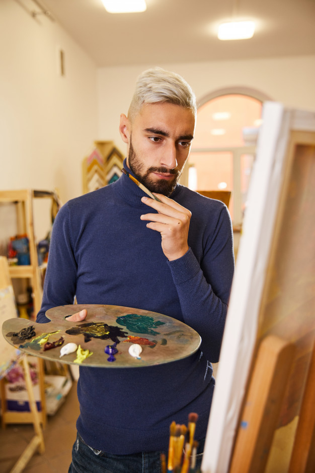 workroom,photogenic,gouache,attire,blond,contemporary,casual,handsome,perfect,hold,easel,alone,skill,guy,male,place,inspiration,painter,artist,professional,workshop,best,young,picture,europe,workplace,think,usa,painting,oil,process,work,brush,man
